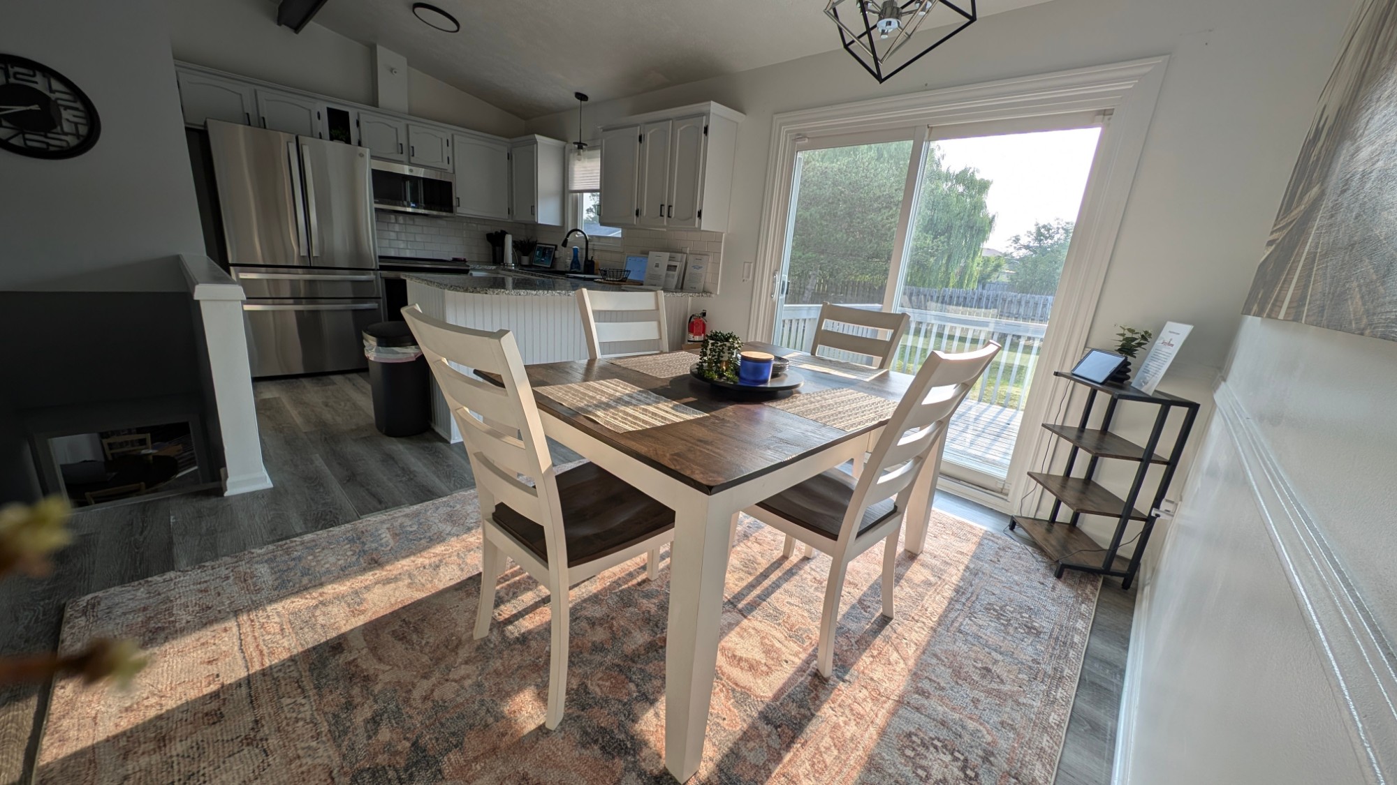 Dining table and open kitchen at Kane Homestead with sliding doors to the deck